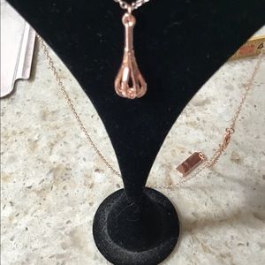 Rose gold whisk necklace.
